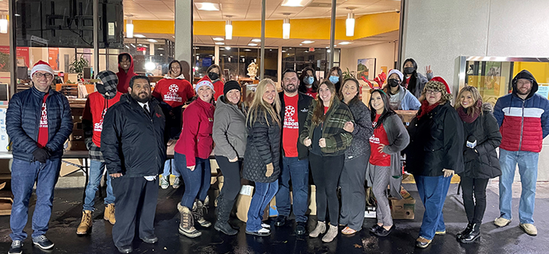 Oroville branch employees supporting donation efforts and wear red holiday sweaters