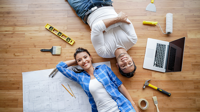 A young happy couple engaging in home remodeling.