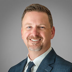 Headshot of Zac Erickson, smiling professionally.