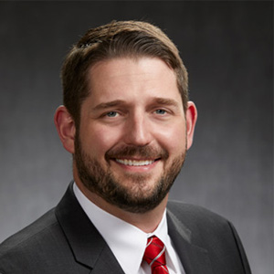 Headshot of Roger Godfrey, smiling professionally.