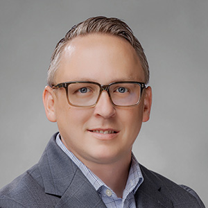 Headshot of Daniel Elliot, smiling professionally.