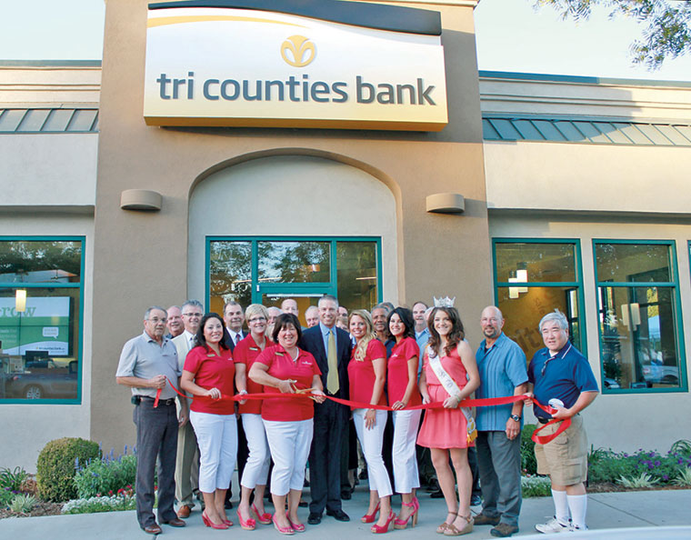 Tri counties bank employees wearing red clothes standing outside a local bank branch