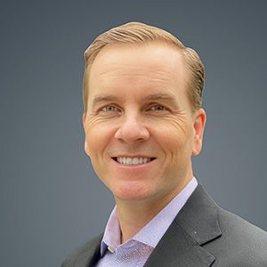 Headshot of Kevin Henz, smiling professionally.