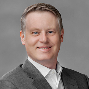 Headshot of Steven Wolf, smiling professionally.